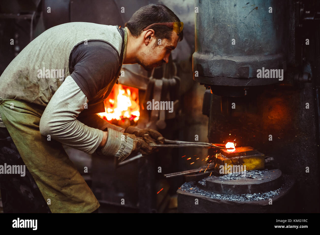 blacksmith working in the on auto hammer Stock Photo Alamy