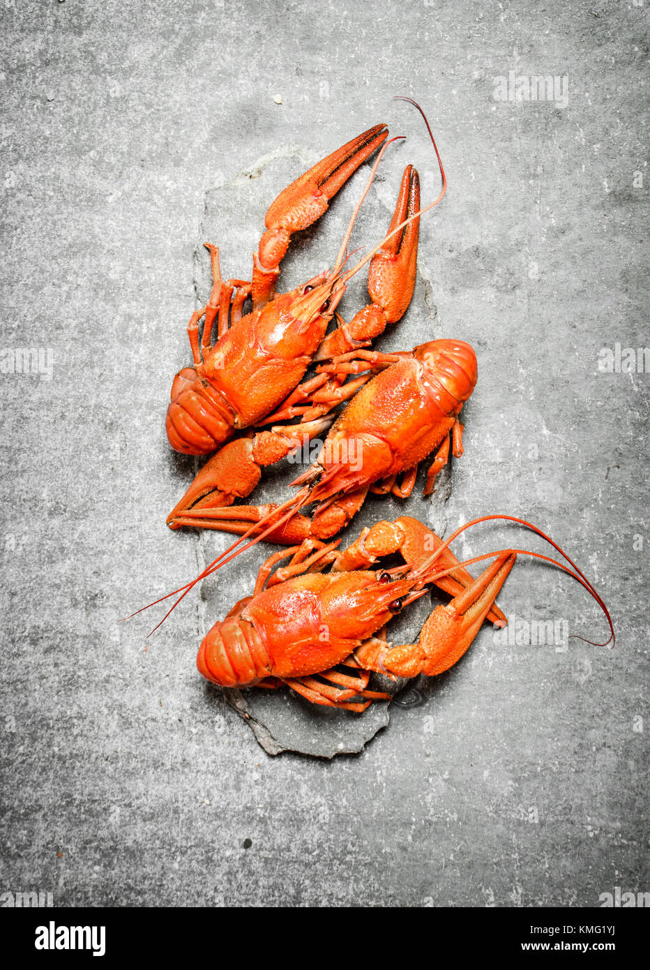Flavorful boiled crawfish. On a stone background. Stock Photo
