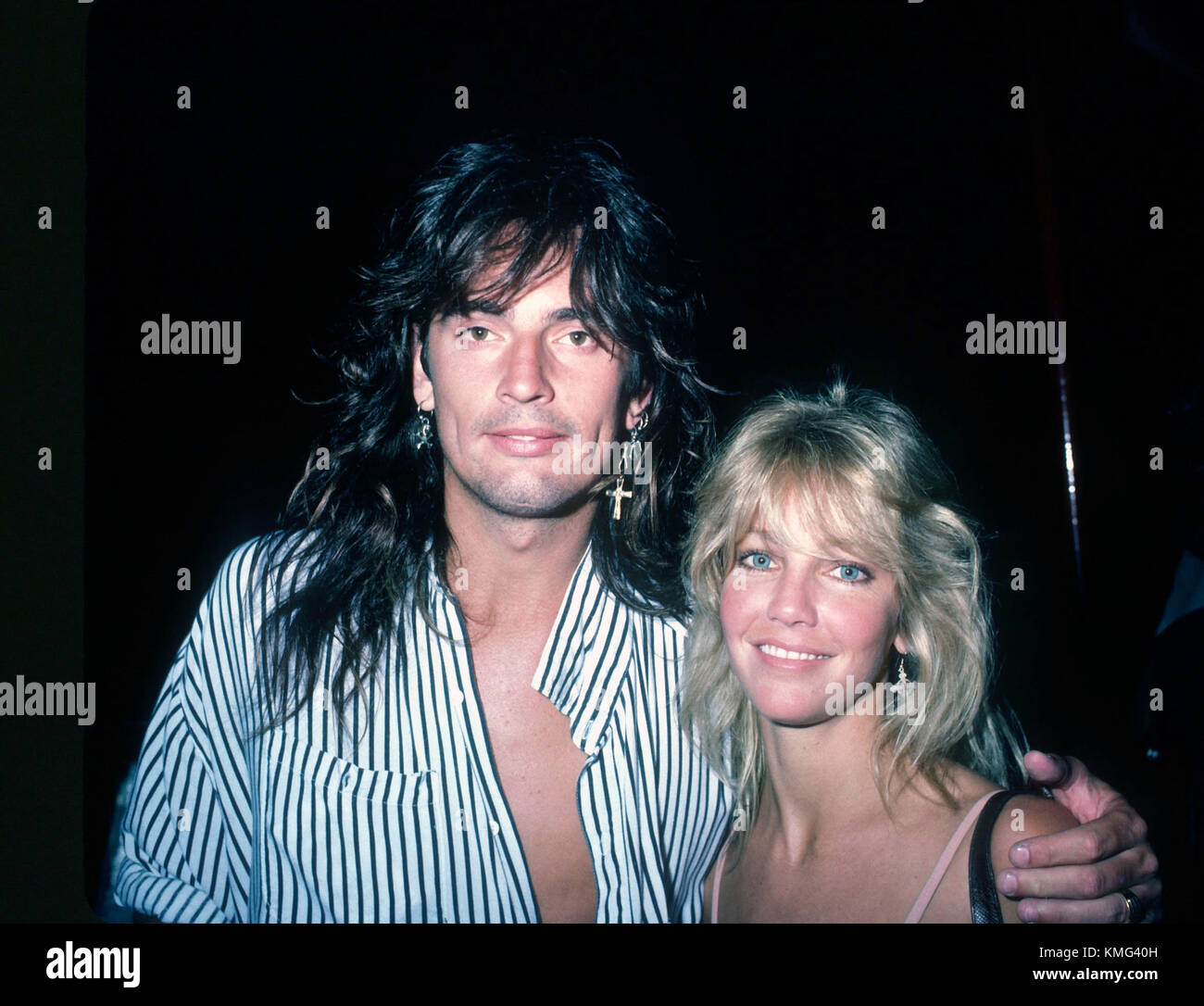 L-R) Musician Tommy Lee and actress Heather Locklear attend Billy Idol  concert backstage at The Forum on May 8, 1987 in Los Angeles, California.  Photo by Barry King/Alamy Stock Photo - Alamy