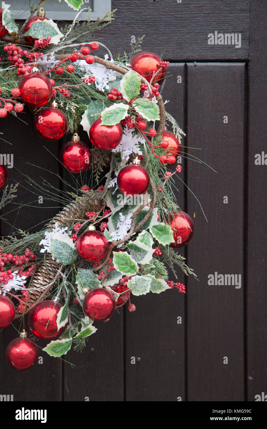 Red Ball Christmas Reef Decoration on Front Door Stock Photo - Alamy
