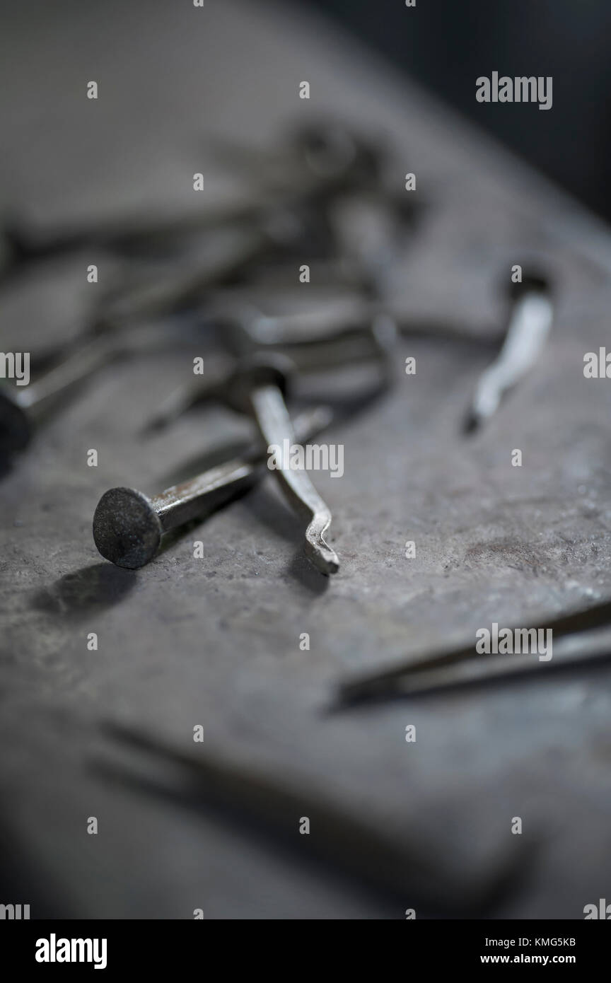 Handmade nails on anvil at blacksmith shop Stock Photo
