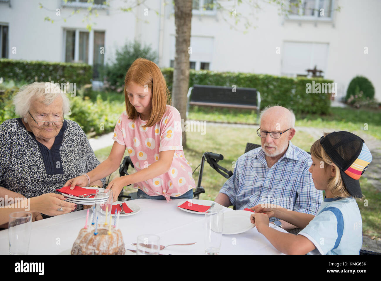 Family setting table outdoors Stock Photo