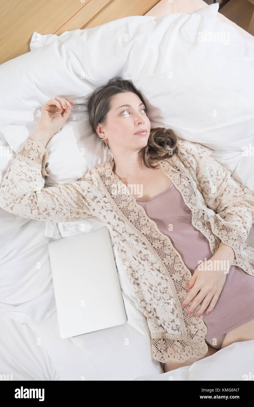 Woman lying on hotel bed hi-res stock photography and images - Alamy