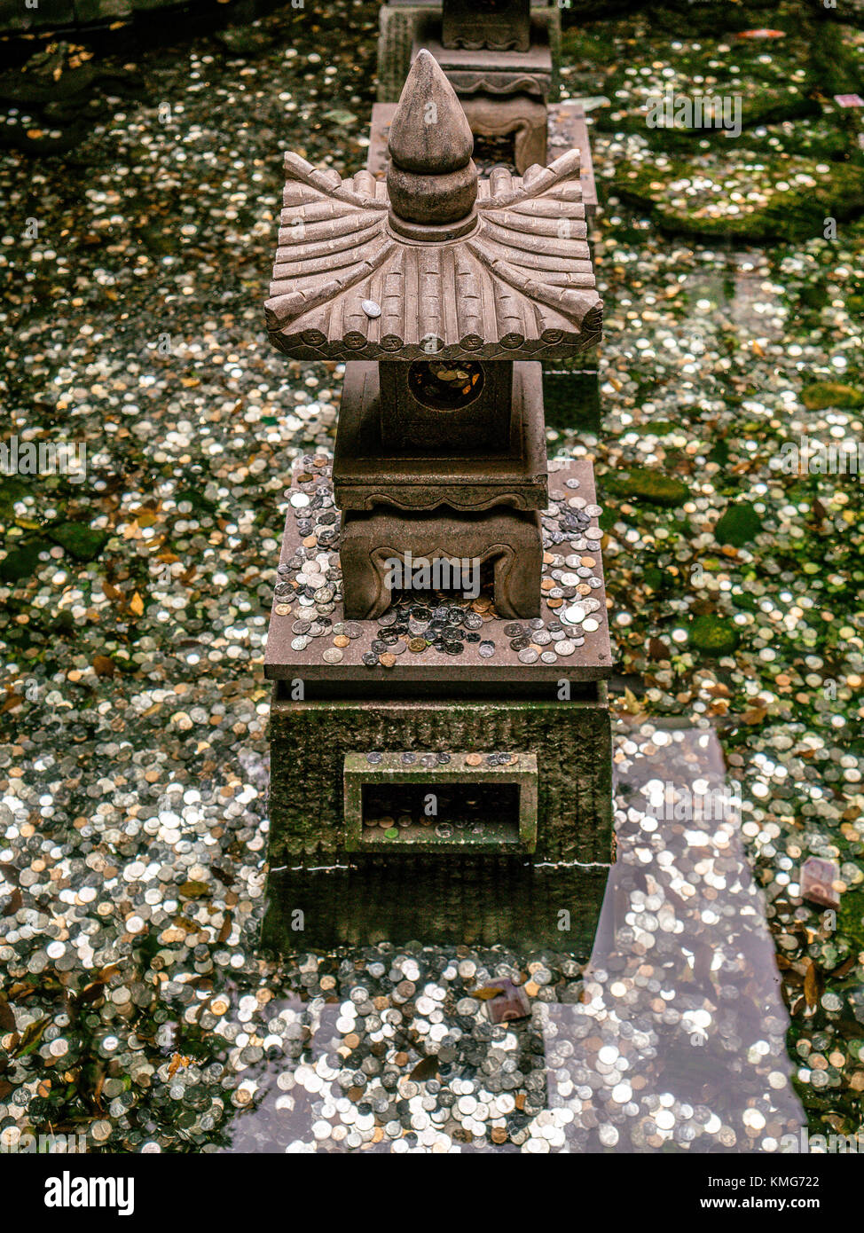 Chinese wish fountains with lot of coins in water - superstition concept Stock Photo