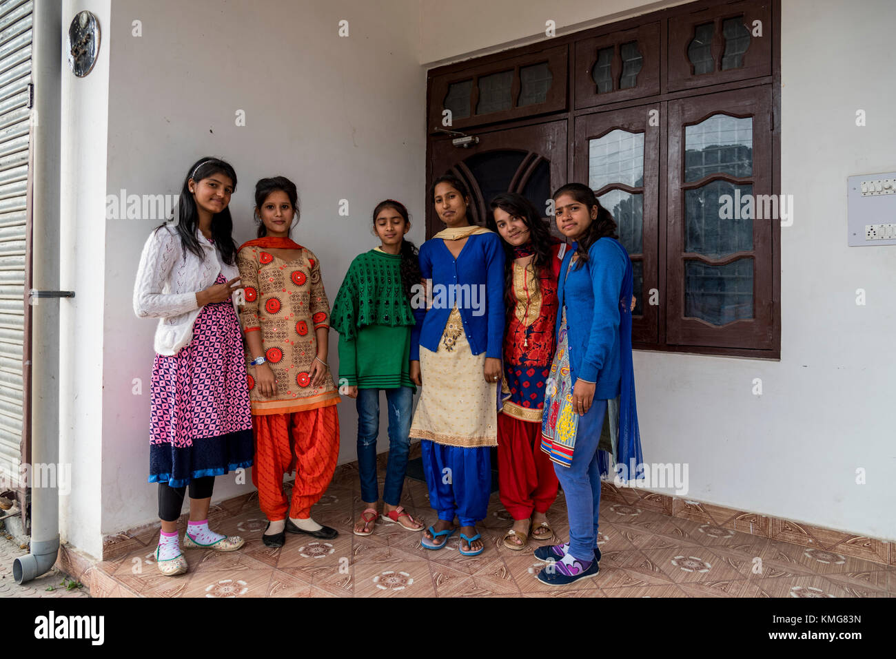 A group of young Indian girls standing in front of their house. Stock Photo
