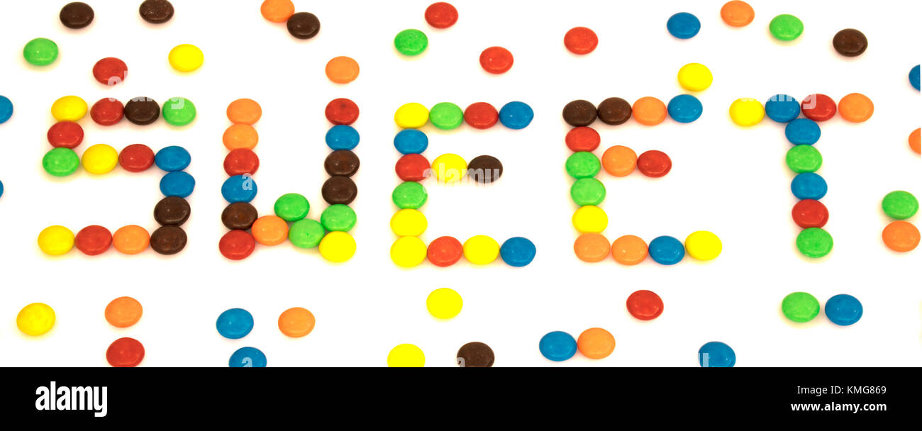 Sweet word written with colorful button shaped chocolates candy isolated on white background