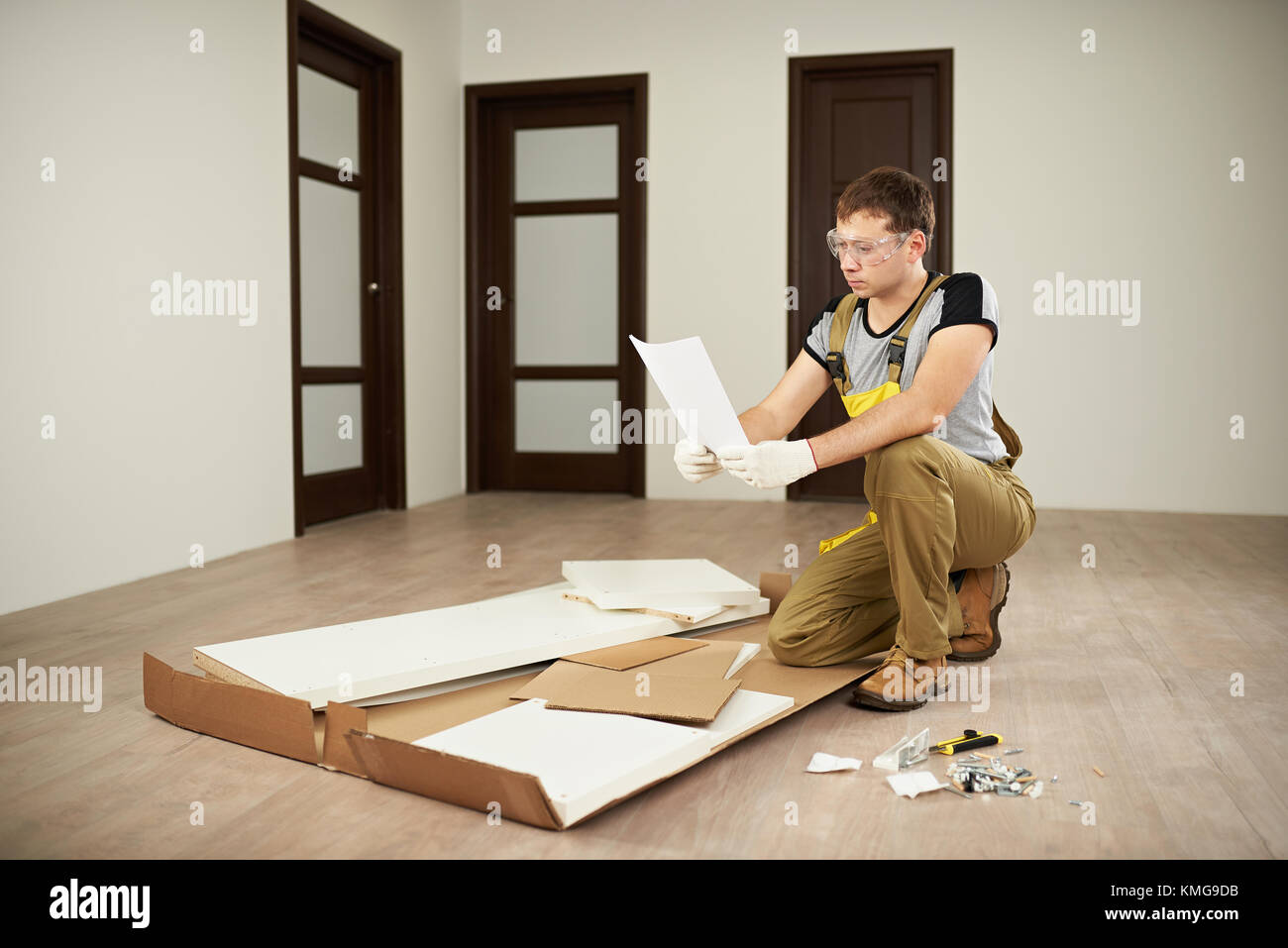 Carpenter checking assemble paper manual. Assembly forniture instructions Stock Photo