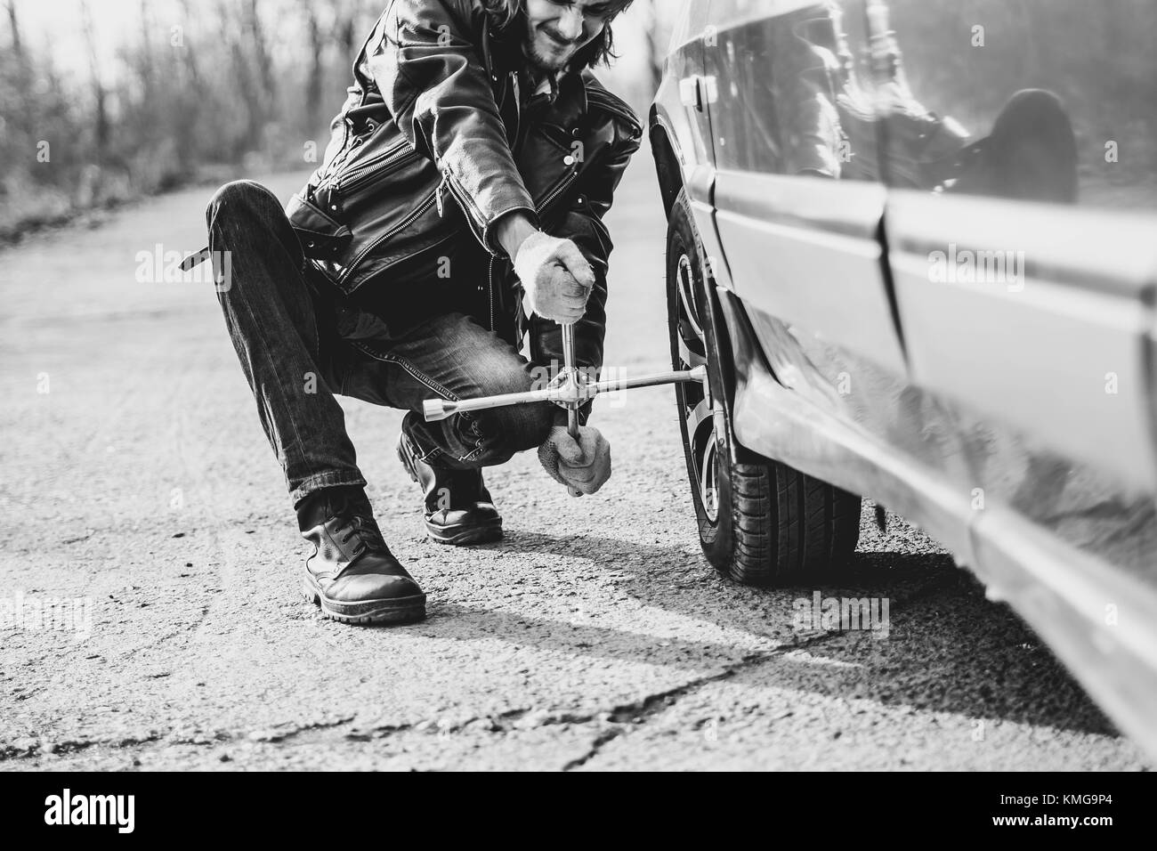 Change a flat car tire on road with Tire maintenance, damaged car tyre