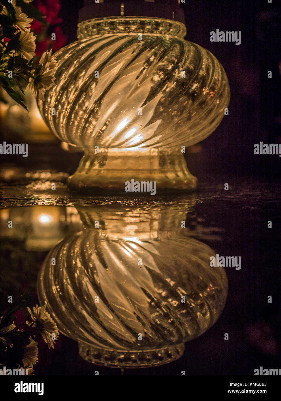 The cemetery torch burns with a bright light in the dark night Stock