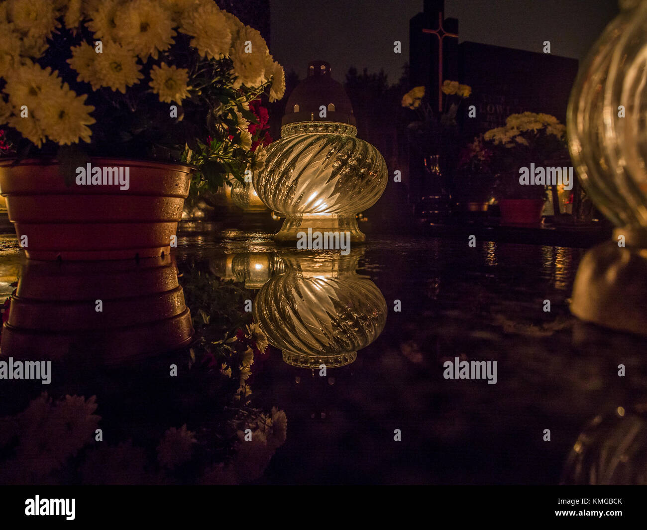 The cemetery torch burns with a bright light in the dark night Stock