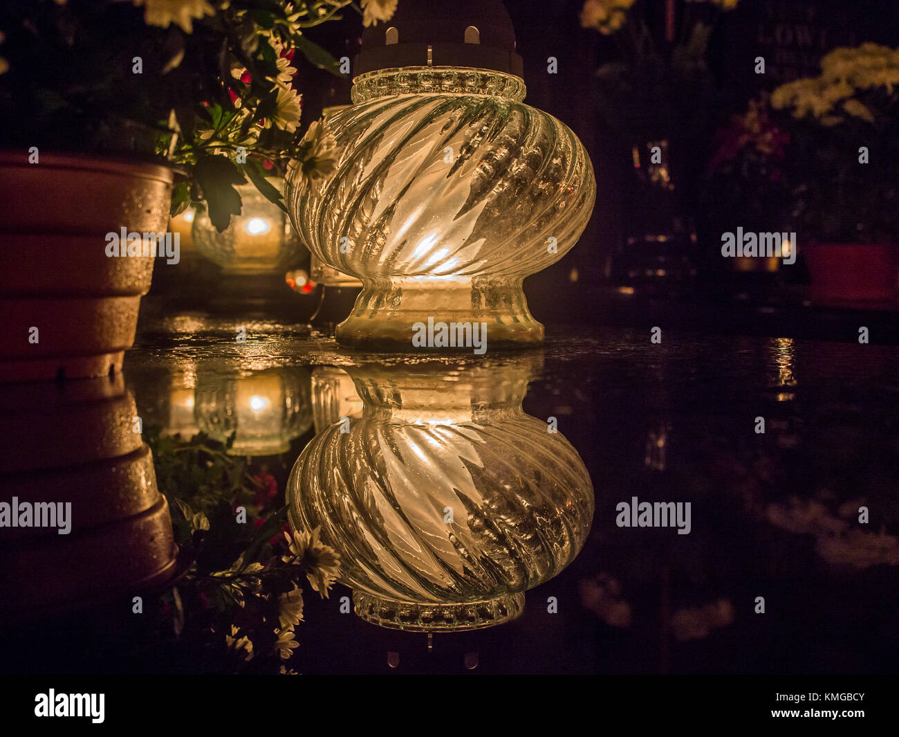 The cemetery torch burns with a bright light in the dark night Stock