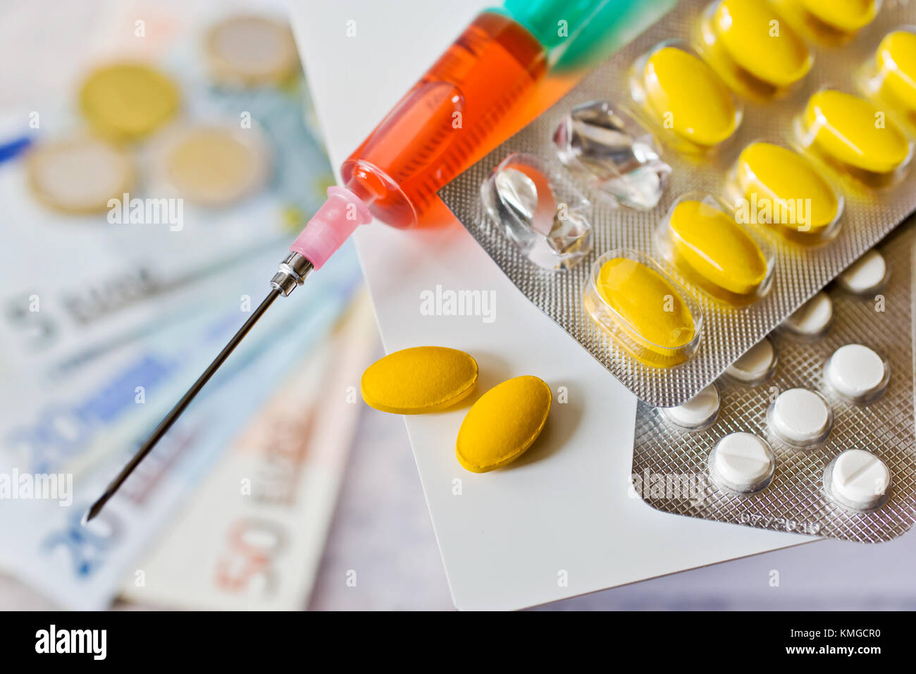Different pills and syringe with Euro money healthcare cost concept