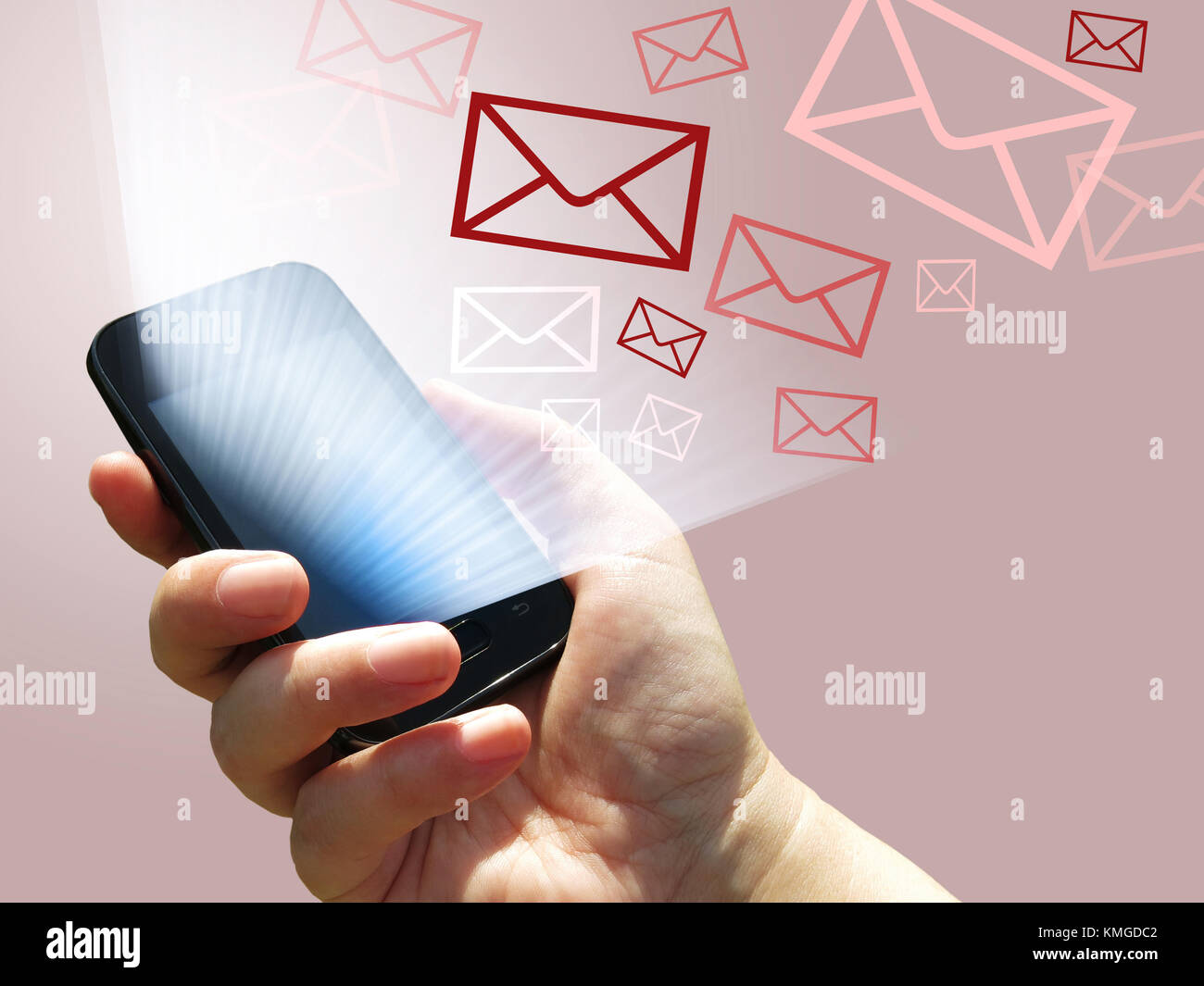 electronic communication - sending e-mails from mobile phone - hand with smartphone and email application Stock Photo
