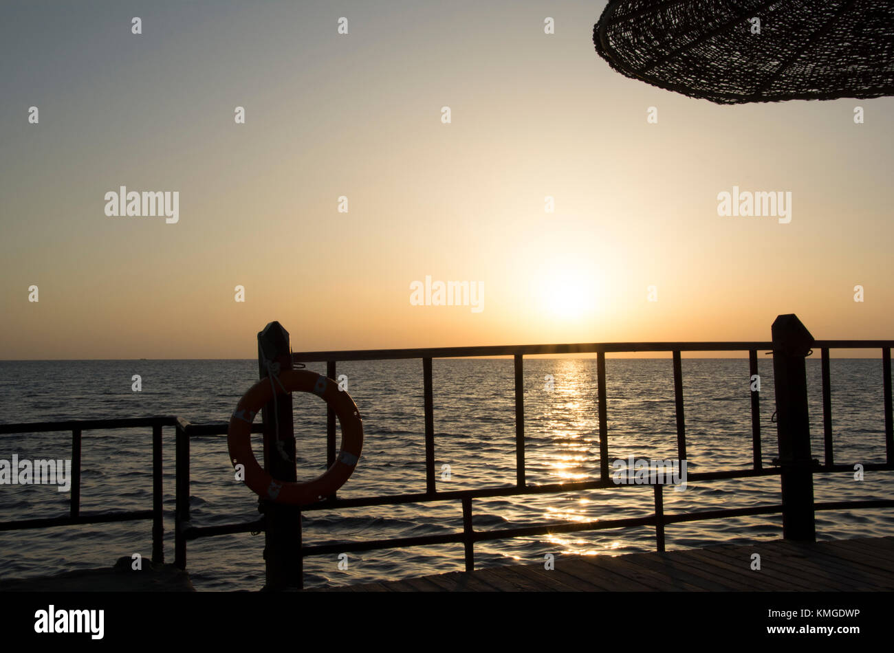 Sunlight over water and pier Stock Photo - Alamy