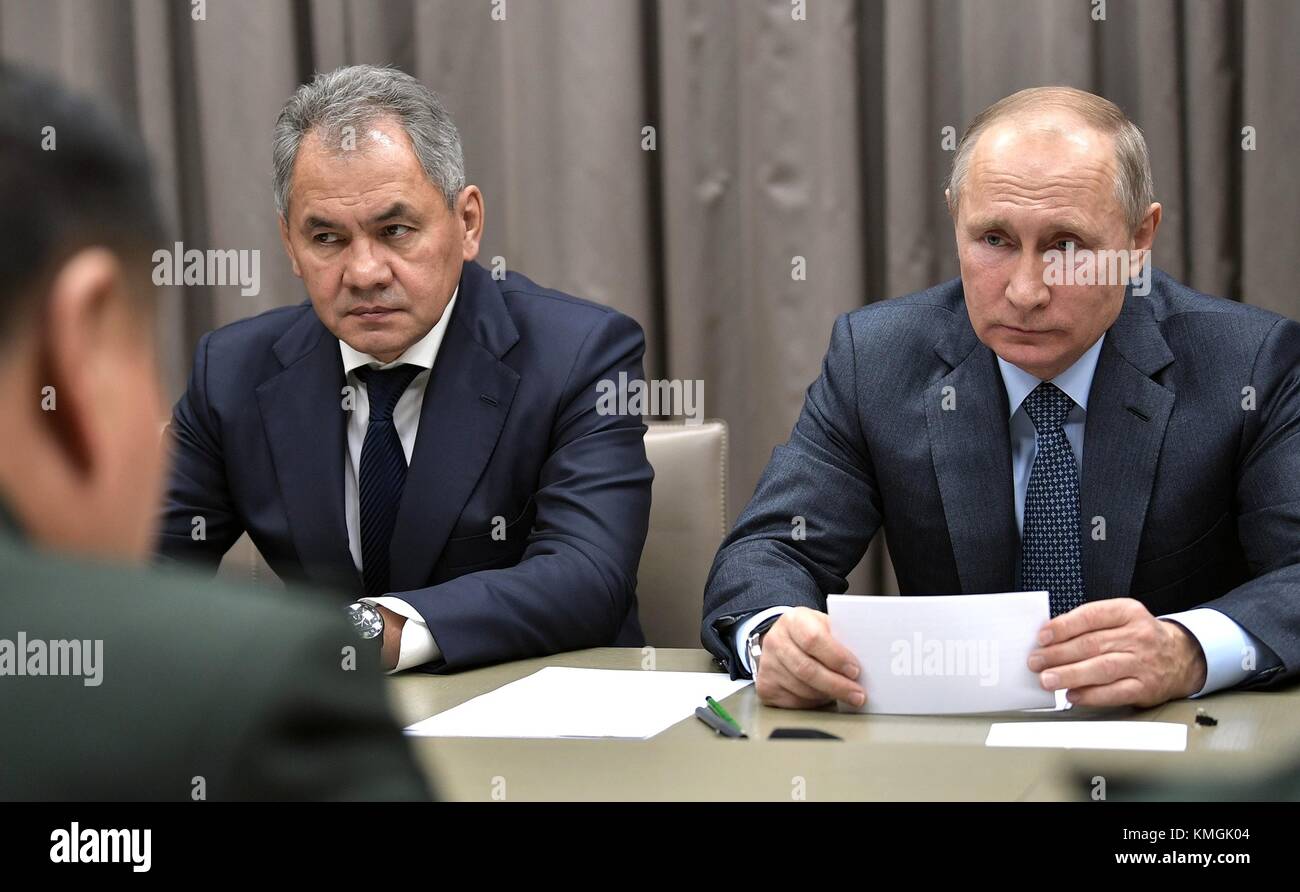Russian President Vladimir Putin, right, and Defense Minister Sergei Shoigu during a meeting with Chinese Communist Party Central Military Commission Vice Chairman Zhang Youxia at the Novo-Ogaryovo residence December 7, 2017 in Moscow, Russia. Stock Photo