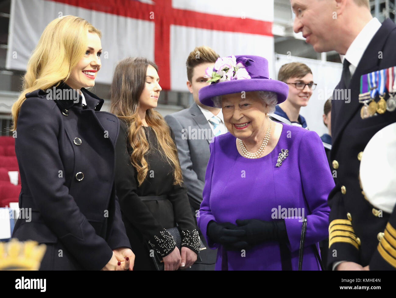 Queen Elizabeth II (centre) with singer Katherine Jenkins (left) and the ship&Otilde;s Captain, Commodore Jerry Kyd (right) during the commissioning of HMS Queen Elizabeth, Britain's biggest and most powerful warship, into the Royal Navy Fleet at Portsmouth Naval Base. Stock Photo