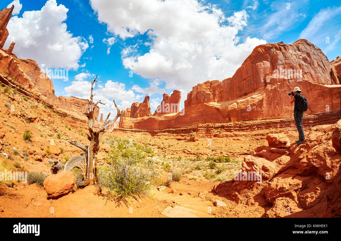 Female photographer takes picture of the Park Avenue Trail in Arches National Park, Utah, USA. Stock Photo