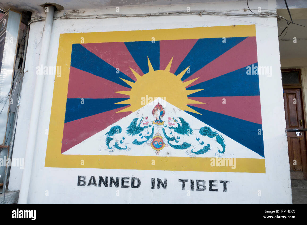 Painting of Tibet flag on wall in Mcleod Ganj, India. Flying the Tibetan flag is banned in Tibet. Stock Photo