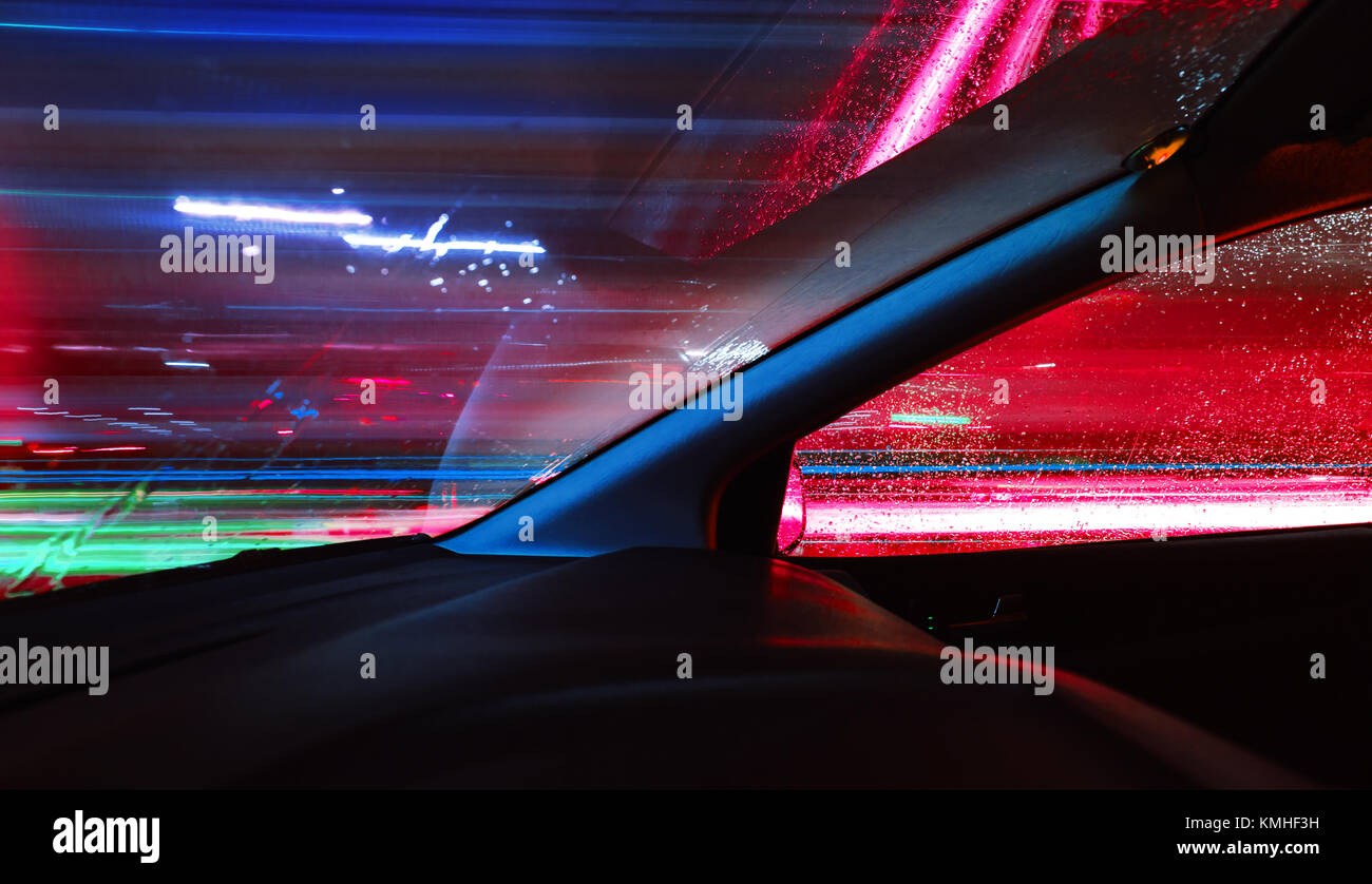 Night driving.Long exposure photo.City colorful night lights perspective blurred by high speed of the car. Stock Photo