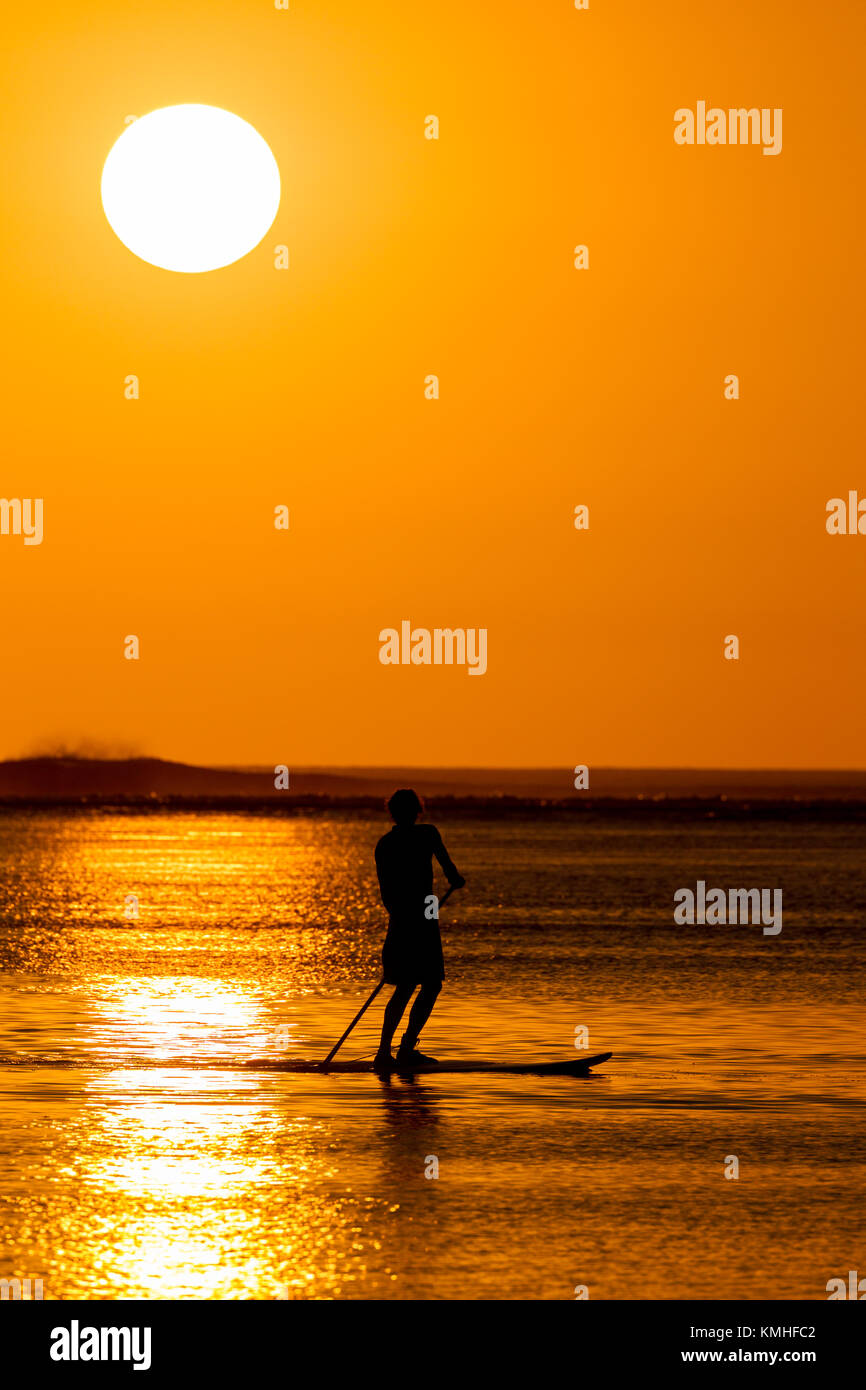 Stand up Paddling at sunset in Le Morne in Mauritius, Africa. Stock Photo