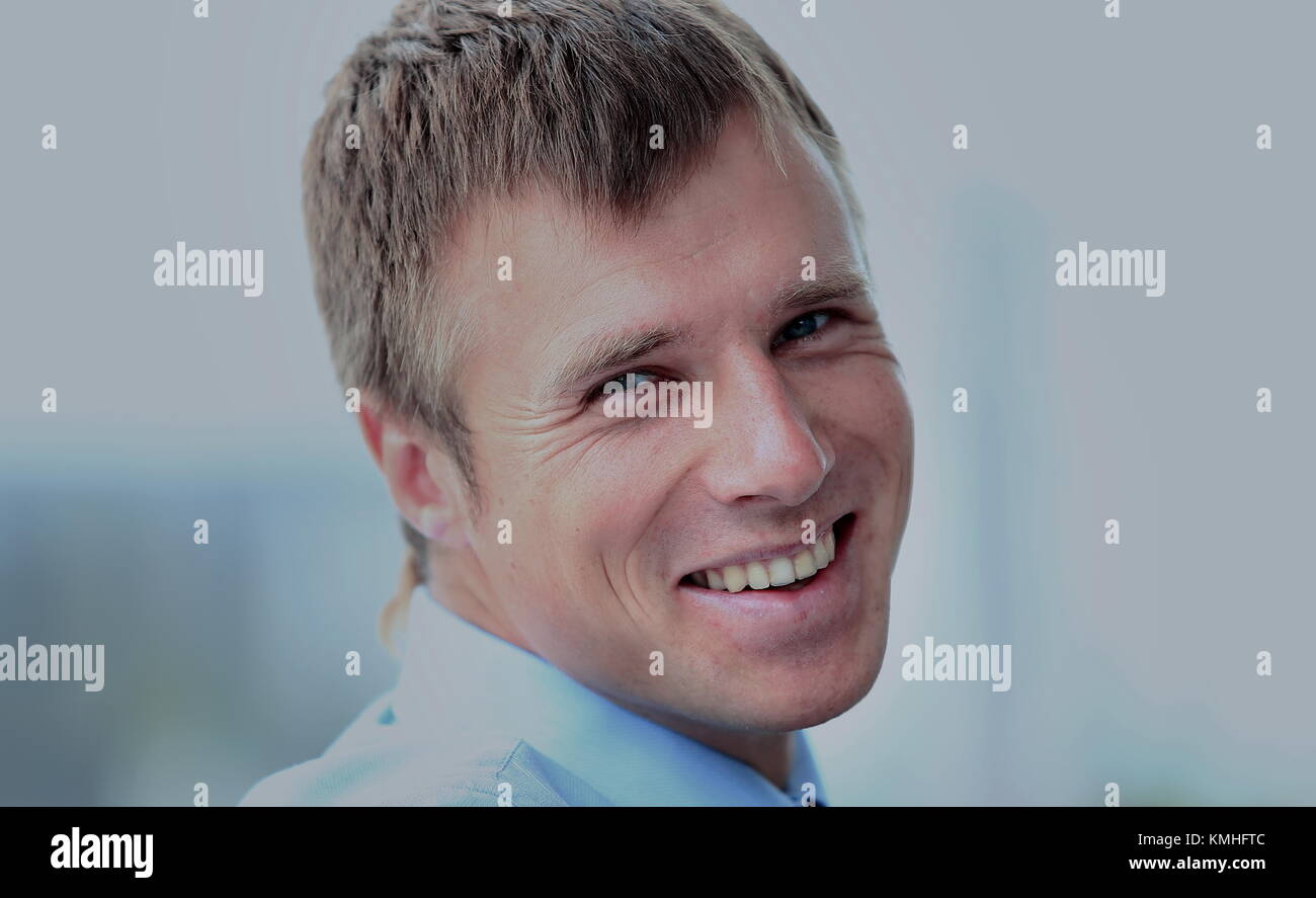 Portrait of smiling young businessman at office Stock Photo - Alamy