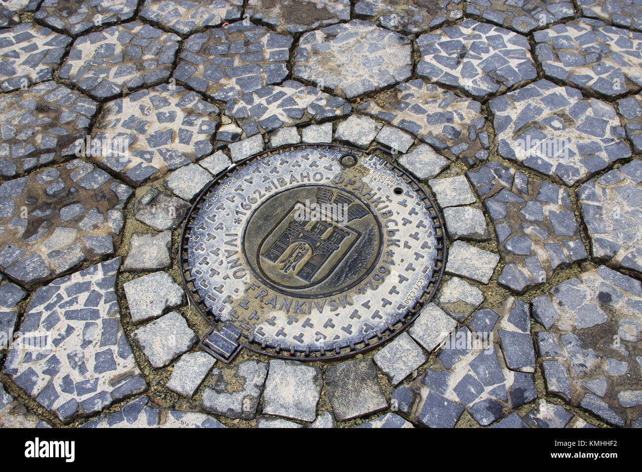 sewerage hatch with emblem of Ivano-Frankivsk on the road Stock Photo