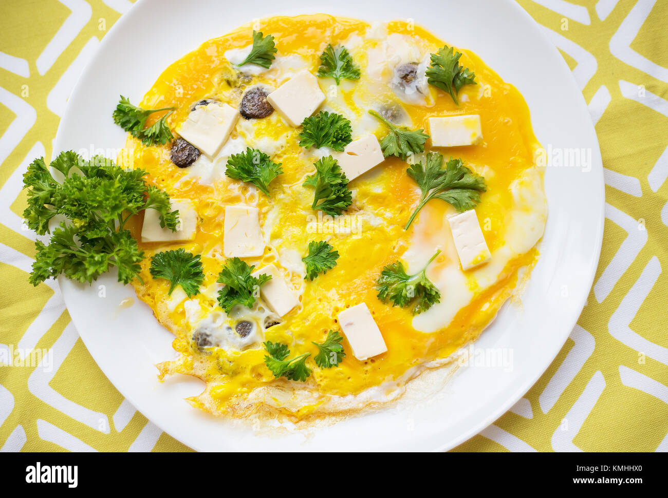 Scrambled eggs with fresh herbs on a plate Stock Photo - Alamy