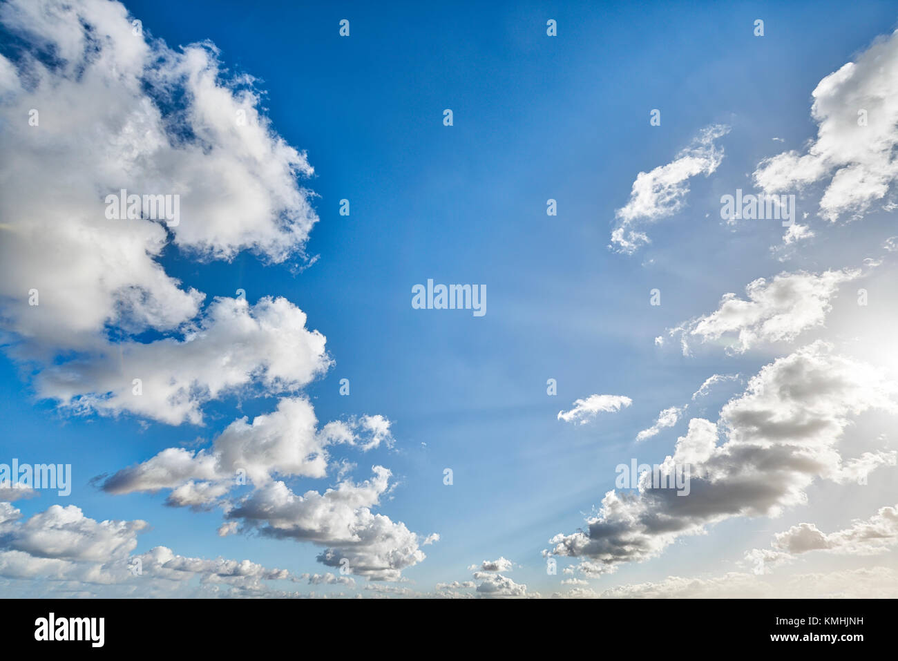 cloudscape with blue sky and sun for backgrounds Stock Photo - Alamy