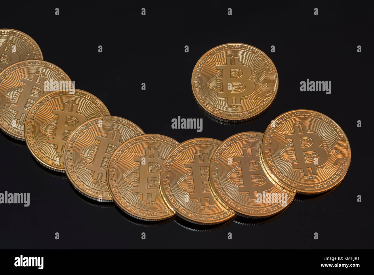 Gold colored Bitcoins - the peer-to-peer payment cryptocurrency reaching high levels in December 2017. Stock Photo