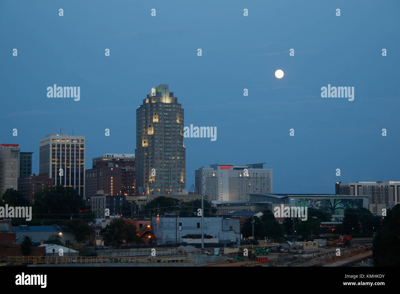 Raleigh, North Carolina skyline at dusk with full moon rising over city ...