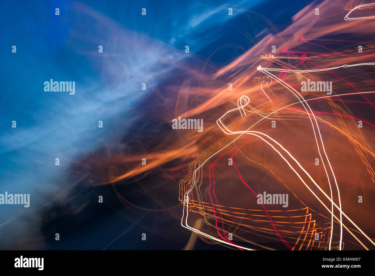 slow motion abstraction on the road. blurred background of car light traces and cloudy night sky. traffic wild energy concept Stock Photo