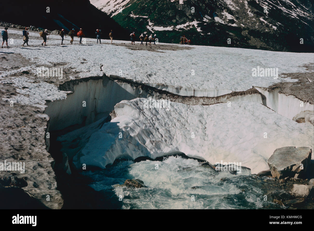 Group of russian hikers crossing Caucasian montains near the river, summer of 1988. Scan of positive slide film. Stock Photo