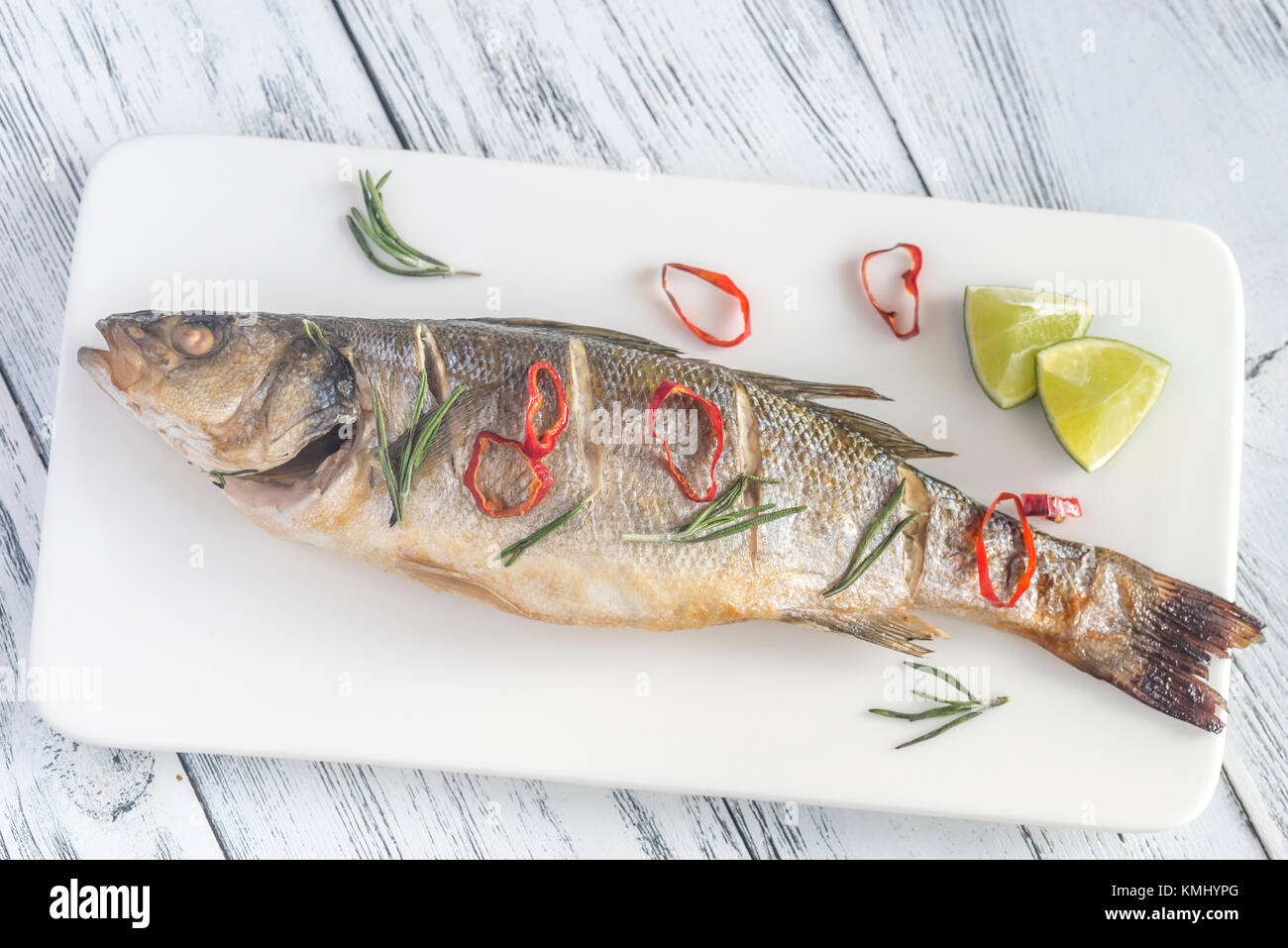 Baked sea bass with lime and chilli pepper Stock Photo Alamy