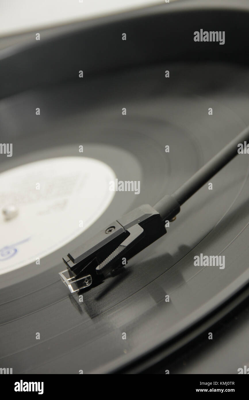 close up of a stylus on a vinyl record. Shot from above with the record played about half way through Stock Photo