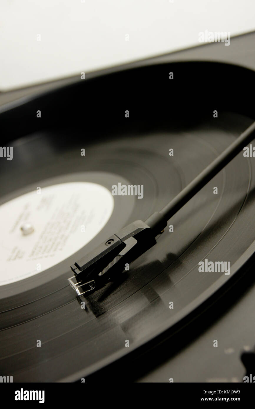 close up of a stylus on a vinyl record. Shot from above with the record played about half way through Stock Photo