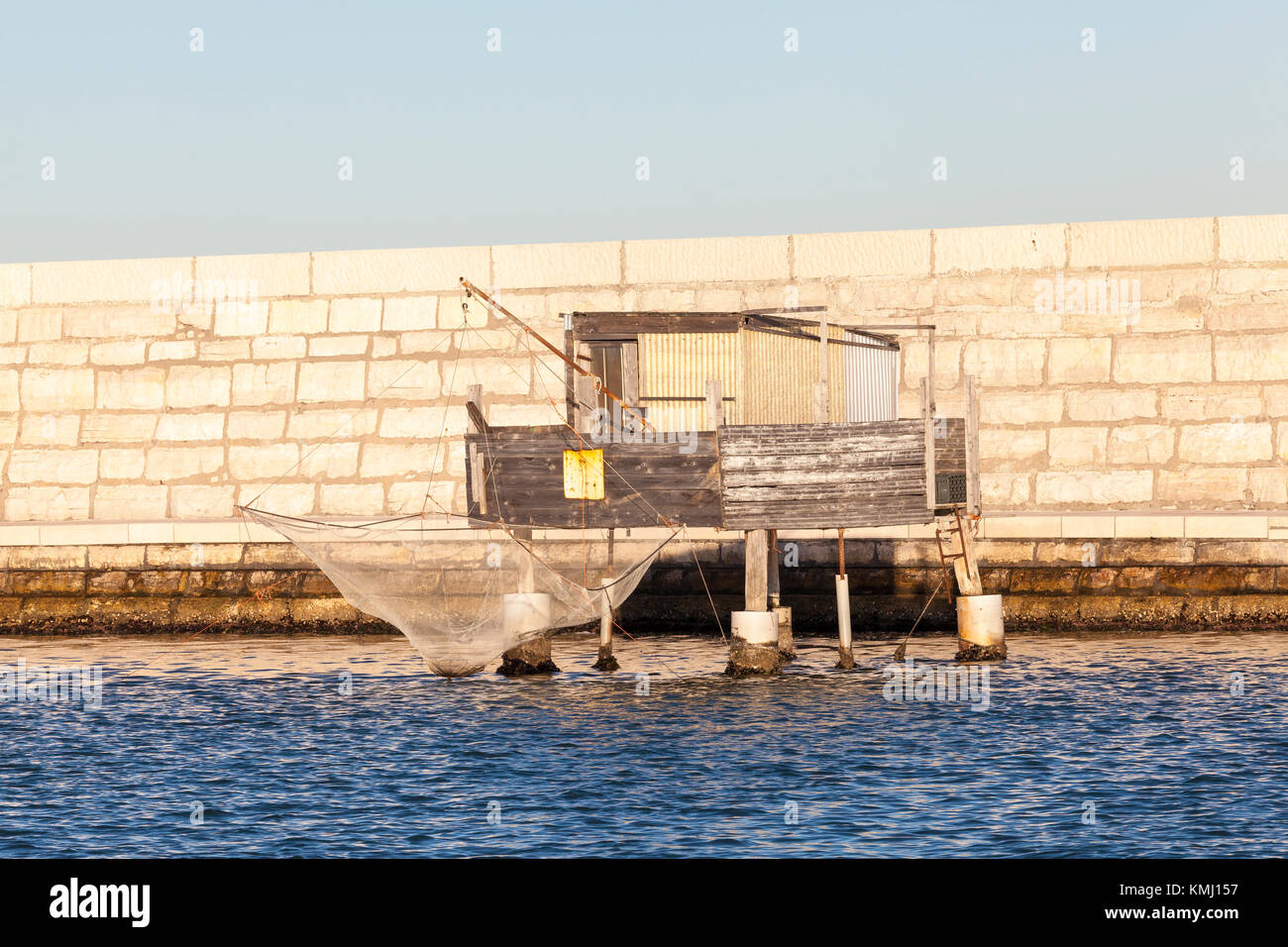 Traditional stilt fishing hut on the Venetian lagoon,  Venice, Veneto, Italy in front of the sea wall built to protect the lagoon from the Adriatic Se Stock Photo