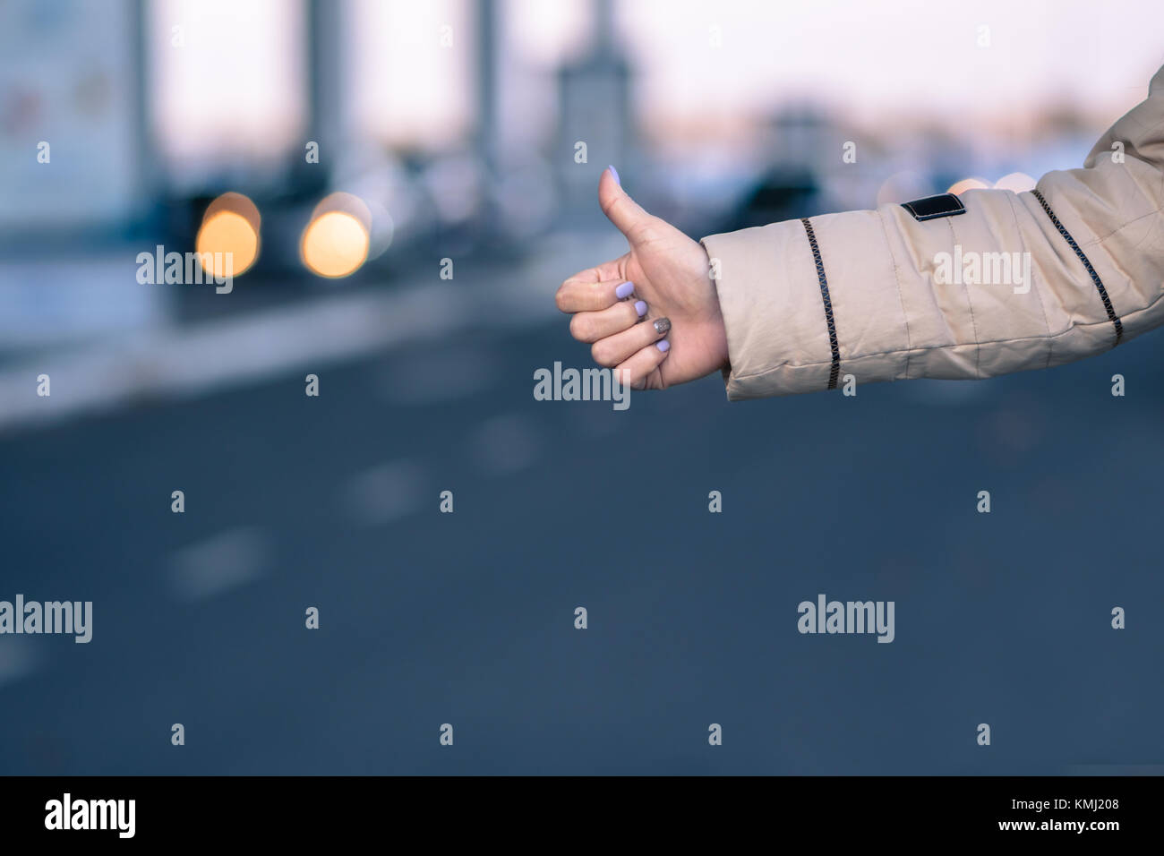 Hand of female hitchhiker girl with blurred lights and city on background Stock Photo Alamy