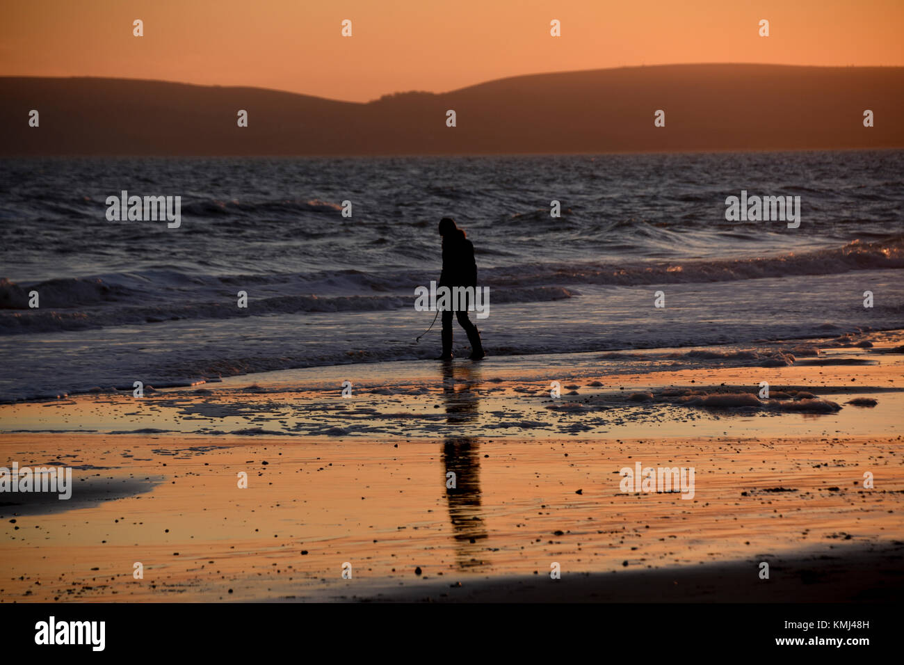 People on the beach at sunset in Silhouette Stock Photo - Alamy