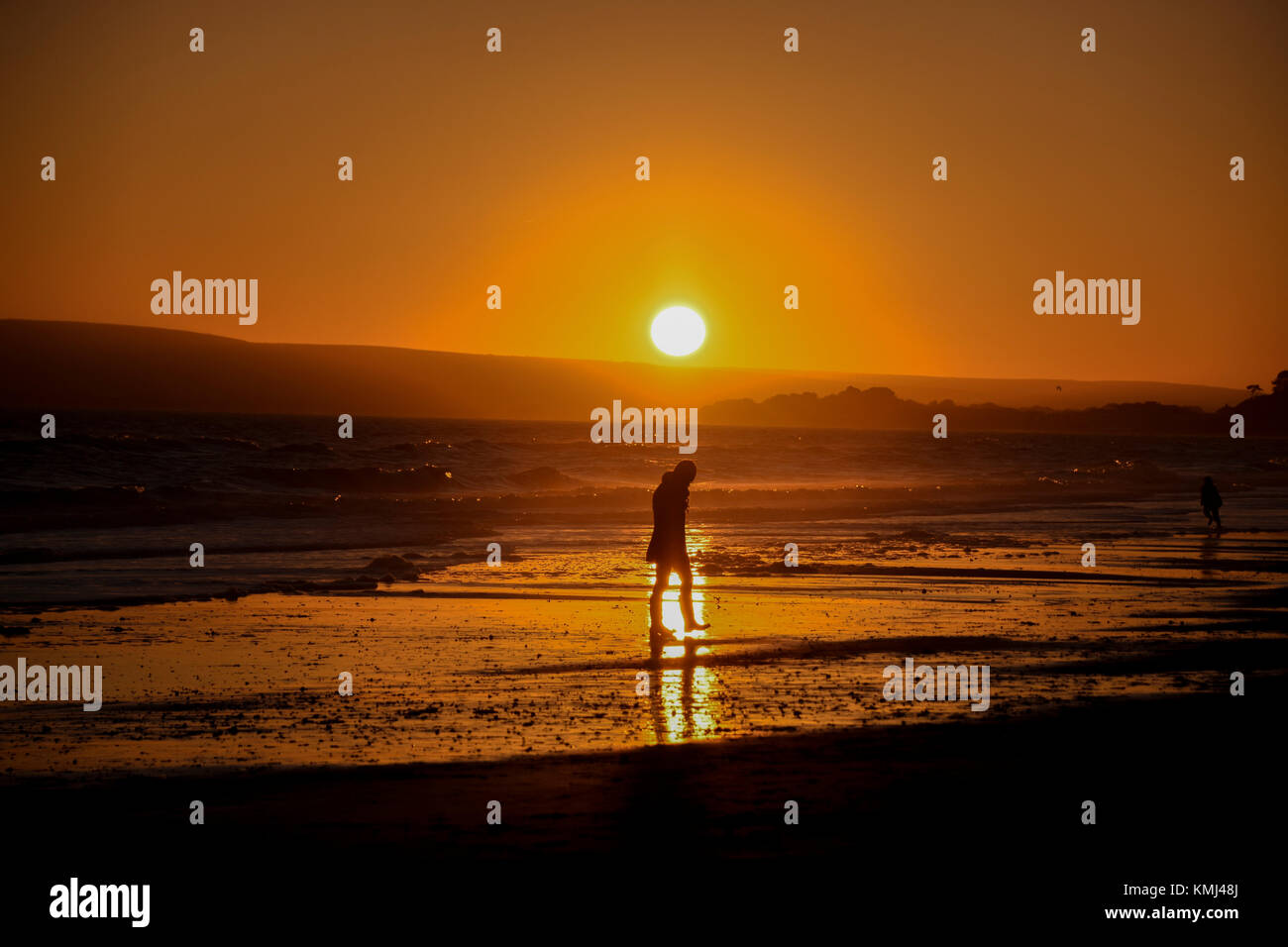 People on the beach at sunset in Silhouette Stock Photo - Alamy