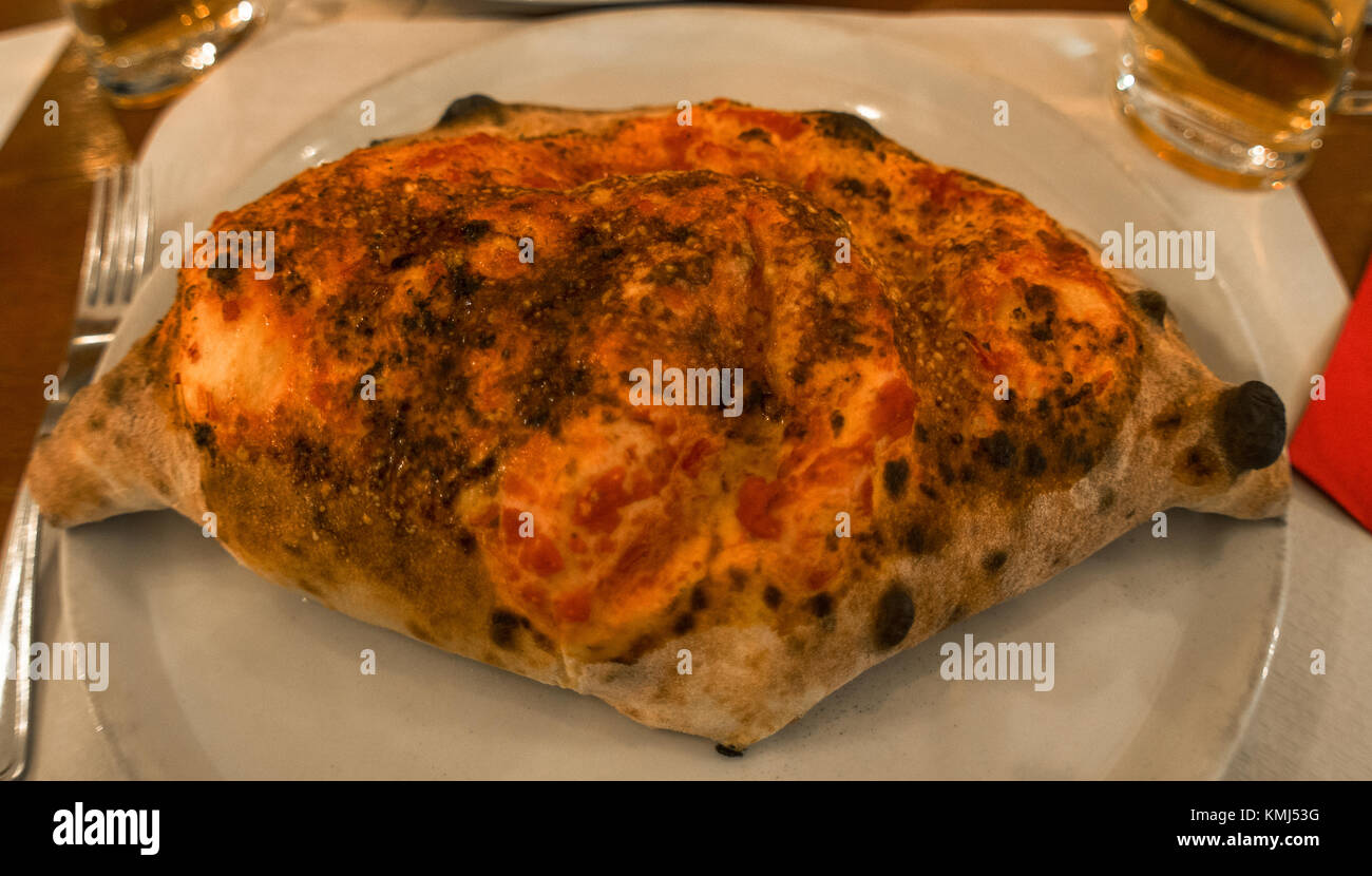 calzone, it's a pizza of Naples,stuffed with cheese and cured meat Stock Photo