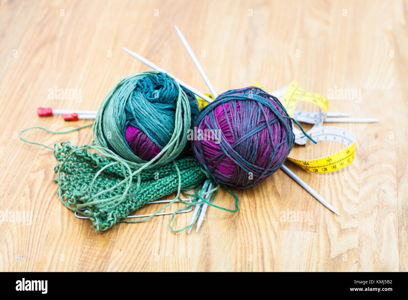 needlework still life - hand knitting tools and wool yarns on wooden table  Stock Photo - Alamy