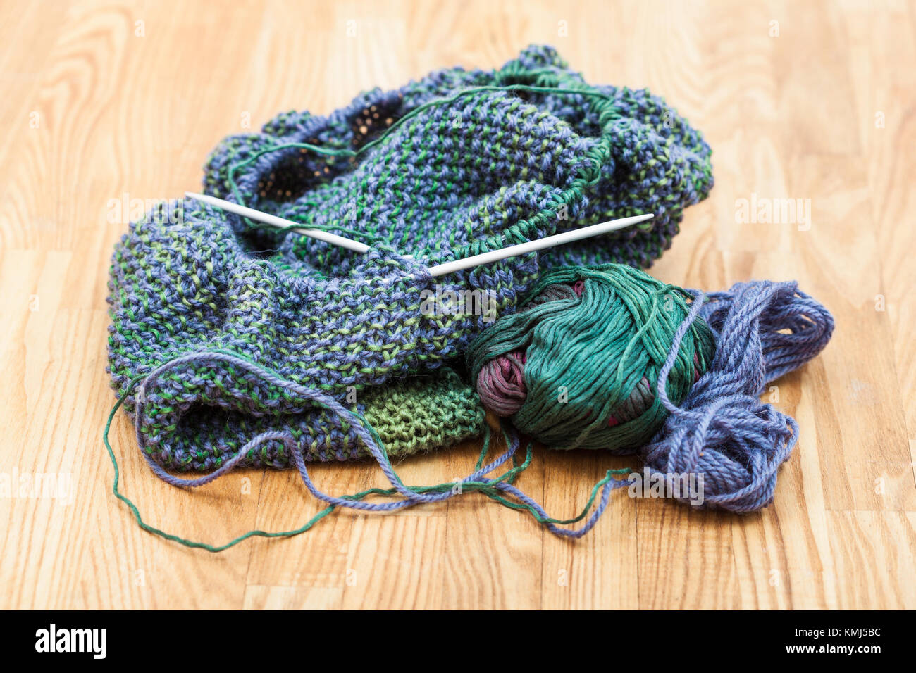 handknitted cloth and knitting tools on wooden table Stock Photo Alamy