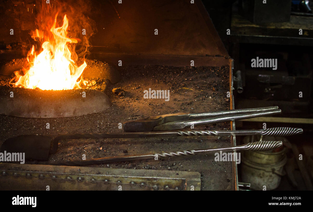 Blacksmith at work, hit with a hammer by a hot metal on the anvil. Stock Photo