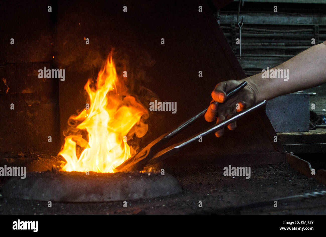 Blacksmith at work, hit with a hammer by a hot metal on the anvil Stock