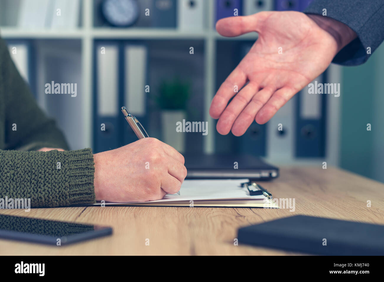 Boss giving orders and work tasks with assignment to be improved. Male hand pointing to female employee's paperwork. Stock Photo