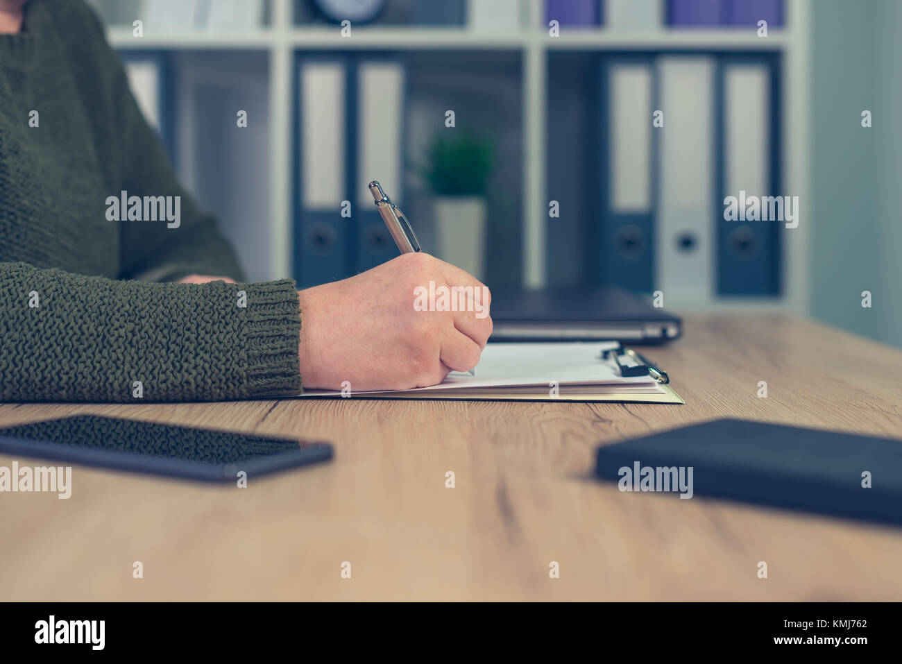 Female entrepreneur signing business contract agreement in home office interior Stock Photo