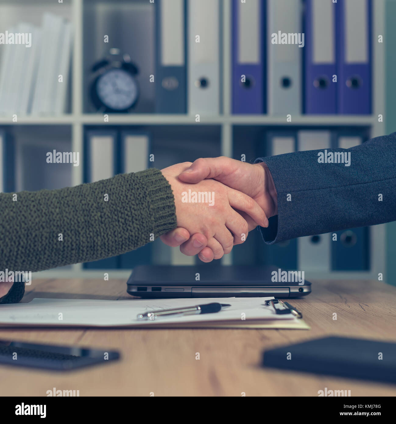 Man and woman shake hands over business agreement. Start up business female entrepreneur making handshake deal with large corporate company Stock Photo