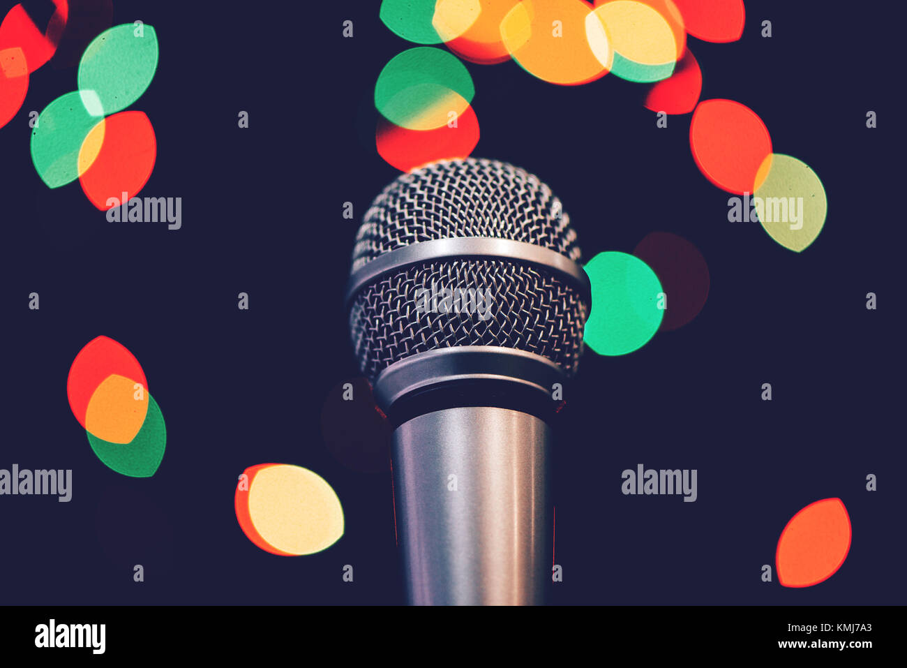 Audio microphone on stage with bokeh light. Music concert or talent show concept with copy space. Stock Photo