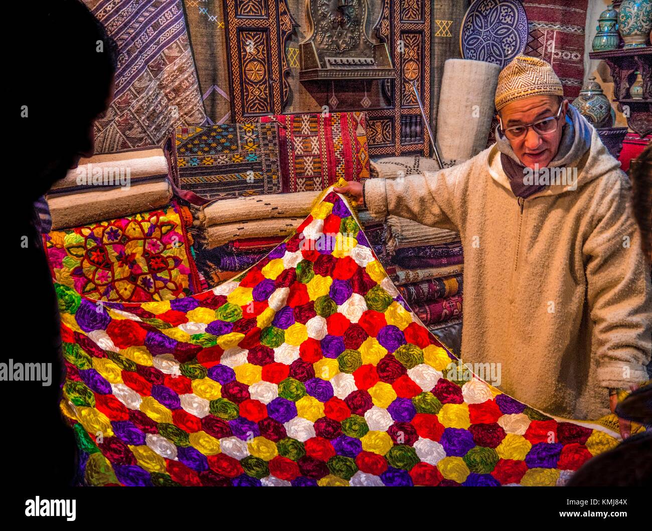 Morocco, Fes, in an antik shop, dealing on a hand made silk linned, 18th Century, in the ''Medina'' (old part) of Fes. Stock Photo