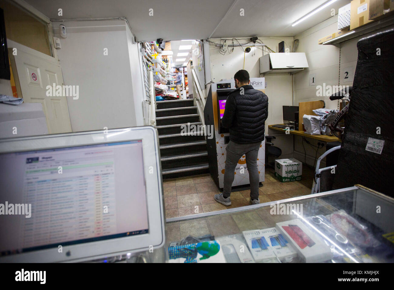 A customer uses a Bitcoin machine in Goodge Street in London, as the cryptocurrencie's relentless rise continued on Thursday, shooting past the $16,000 (&pound;12,000) mark and adding to fears of a dangerous market bubble. Stock Photo